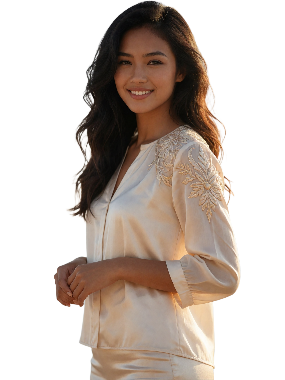 Warm, radiant Filipina woman in an elegant ivory blouse with champagne embroidery smiling with natural eye contact